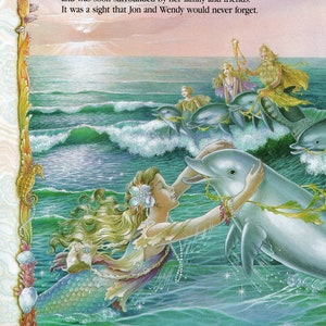 May include: A mermaid with long blonde hair and a green tail swims with a dolphin. The mermaid is wearing a purple and green top and a pearl necklace. The dolphin is gray and has a white belly. The background is a blue ocean with waves and a pink sunset.