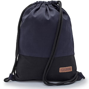 May include: A navy blue and black drawstring bag with a brown leather patch that says "LEON".