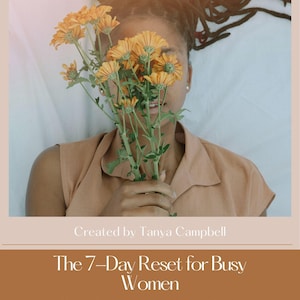 May include: A book cover with a woman holding orange flowers, with the text "The 7-Day Reset for Busy Women" and "A Gentle Rest For Your Mind, Body, & Habits". The cover is in shades of brown and beige.