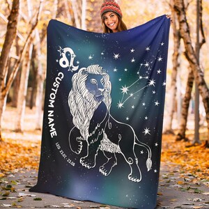 May include: A blue and green fleece blanket with a white outline of a lion and the zodiac symbol for Leo. The blanket also has white stars and the text "CUSTOM NAME LEO 23.07. - 23.08."