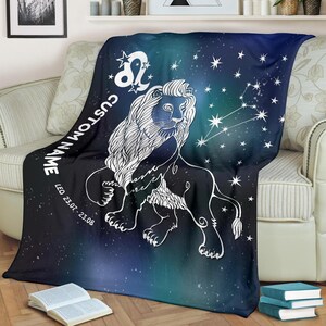 May include: A soft, blue and black fleece throw blanket with a white outline of a lion and the zodiac symbol for Leo. The blanket has a starry night sky background with the text "CUSTOM NAME" and "LEO 23.07 - 23.08" printed on it.