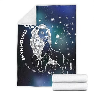 May include: A blue and purple galaxy-themed throw blanket with a white outline of a lion and the constellation Leo. The text "CUSTOM NAME" and "LEO 23.07. - 23.08." is printed on the blanket.