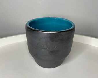 Metallic black and teal ceramic cup
