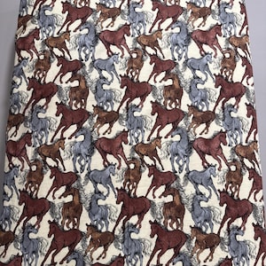 May include: Fabric with a repeating pattern of running horses in shades of brown, gray, and tan. The horses are depicted in a detailed, illustrative style, creating a dynamic and textured design. The fabric has a neutral background.