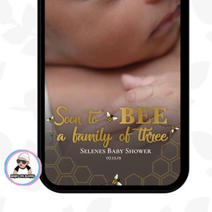 May include: A phone screen displaying a baby shower announcement with a gold glitter background and the text "Soon to BEE a family of three". The announcement also includes a honeycomb pattern and a bee illustration.