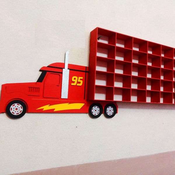 May include: Red toy truck with a large shelf unit attached to the back. The truck has a yellow lightning bolt design and the number 95 on the side. The shelf unit has 36 square compartments.
