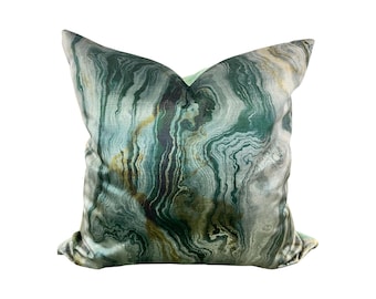 May include: A green, gold, and white patterned throw pillow with a marbled design.