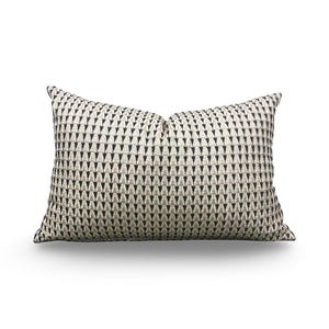 May include: Rectangular decorative pillow with a repeating black arrow pattern on a cream background. The pillow has a soft, textured appearance and is designed for home decor. The pillow is approximately 20 inches long.