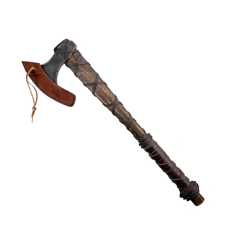 May include: A brown wooden axe with a black metal head and a leather wrap. The axe has a brown leather sheath.