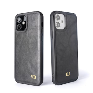 May include: Two black leather phone cases with gold lettering. The case on the left has the initials "VB" and the case on the right has the initials "KJ".