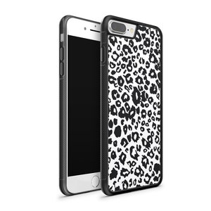 May include: Black and white leopard print phone case for an iPhone. The case is made of hard plastic and has a black border.