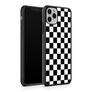 May include: Black and white chequered phone case for an iPhone. The case has a black border and a chequered pattern on the back.
