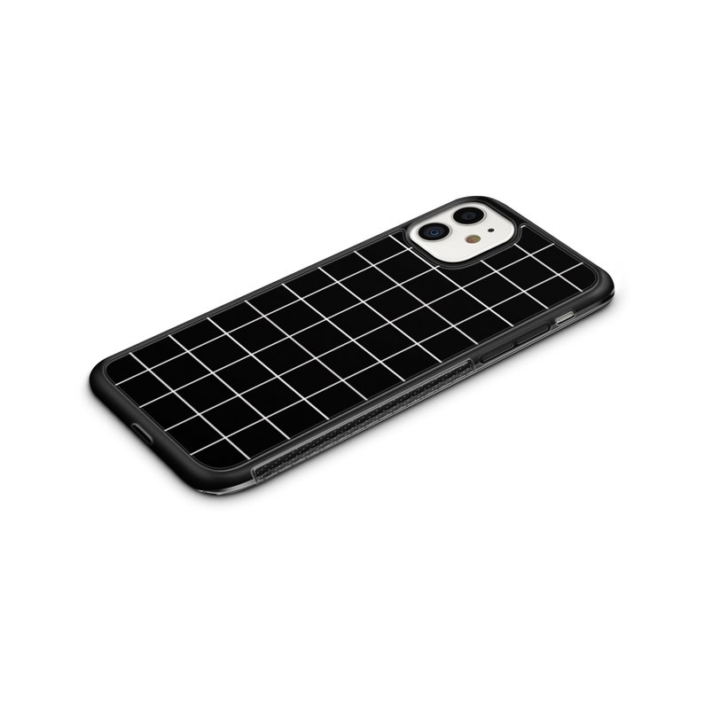 May include: Black phone case with a white grid pattern. The case has a clear back and a black border.