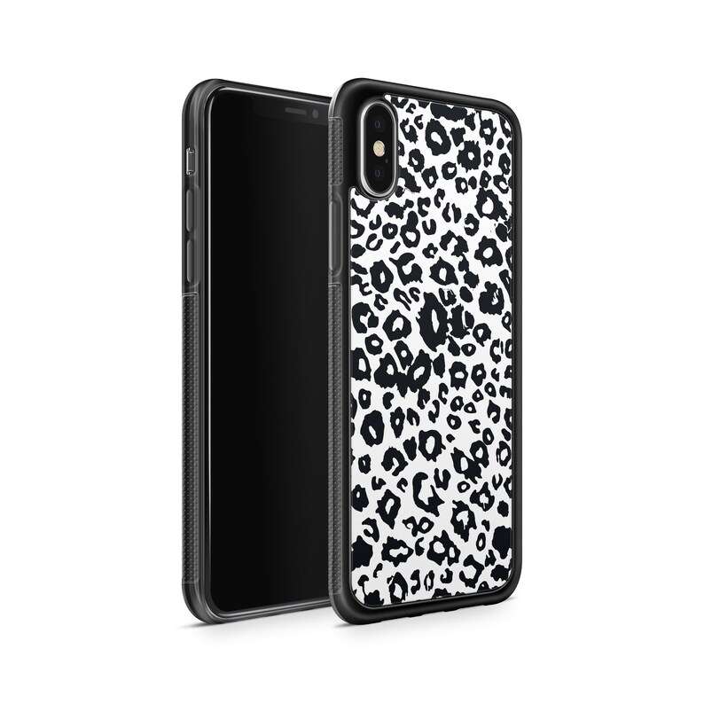 May include: Black and white leopard print phone case for an iPhone X. The case is made of clear, hard plastic and has a black border.