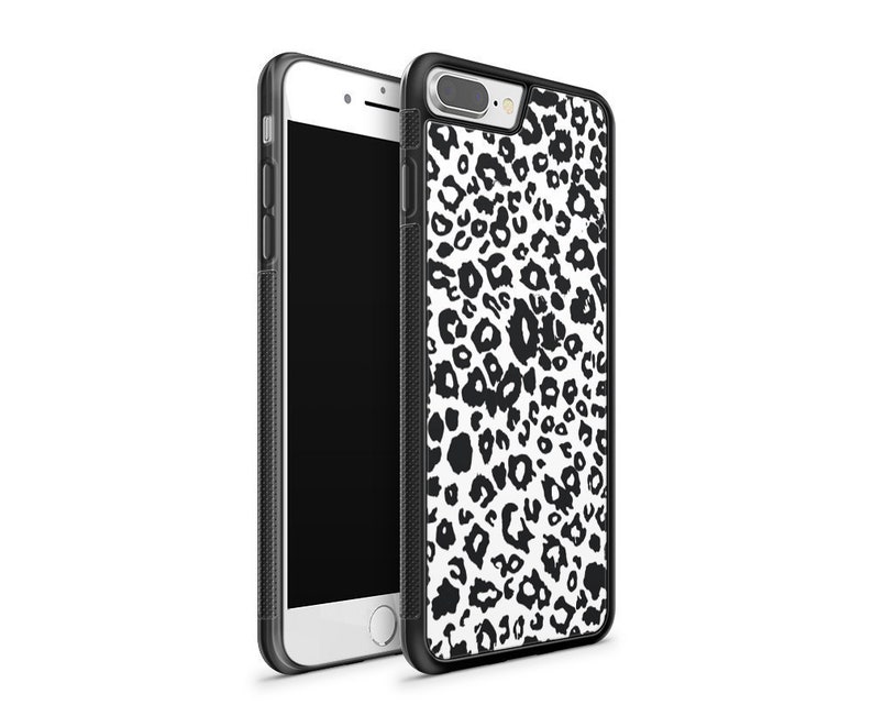 May include: Black and white leopard print phone case for an iPhone. The case is made of hard plastic and has a black border.
