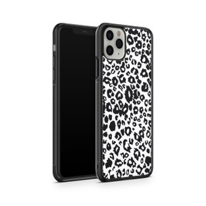 May include: Black and white leopard print phone case for an iPhone. The case has a black border and a clear back.