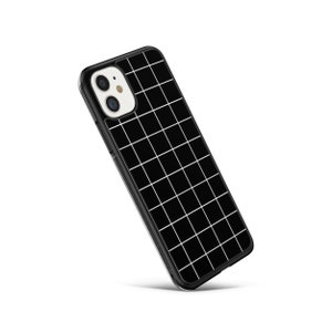 May include: Black phone case with a white grid pattern. The case has a raised camera bump.