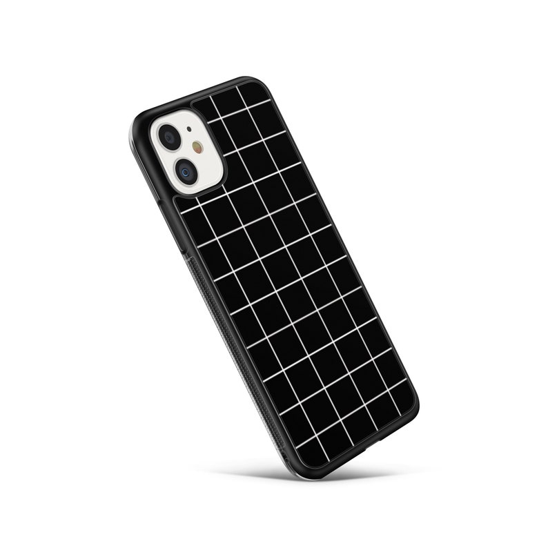 May include: Black phone case with a white grid pattern. The case has a raised camera bump.