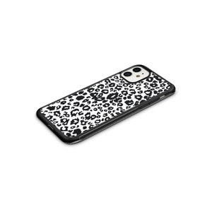 May include: Black phone case with a white and black leopard print design.