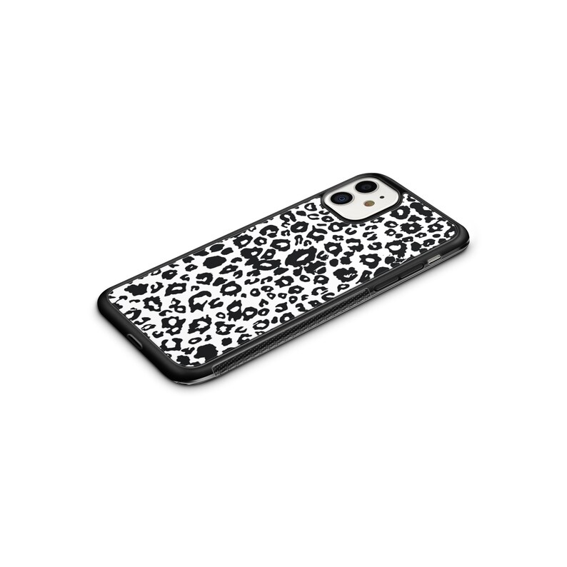 May include: Black phone case with a white and black leopard print design.