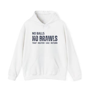 May include: White hoodie with a front pocket and drawstring. The front of the hoodie features the text "NO BALLS NO BRAWLS" in dark blue, with "TRAP • NEUTER • VAX • RETURN" below. A casual, comfortable garment.