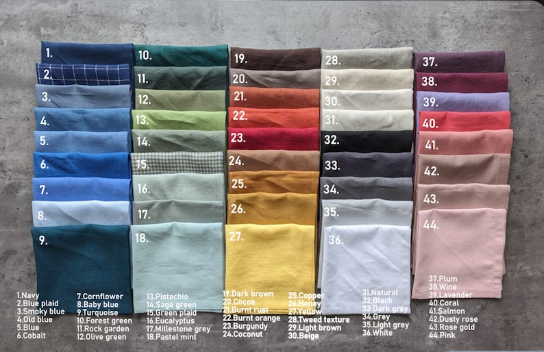 May include: A color chart displaying a variety of fabric swatches. The swatches are arranged in rows and columns, showcasing a wide spectrum of colors, including blues, greens, browns, and pinks. Each swatch is labeled with a number and color name.