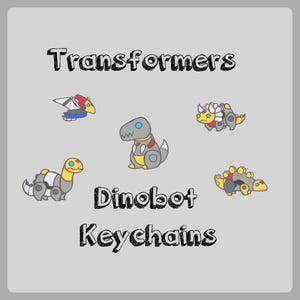 May include: A light gray background features the text "Transformers Dinobot Keychains." Five cartoon Dinobot keychains are displayed. The keychains are in various colors, including yellow, gray, red, and blue. The keychains are in the shape of dinosaurs.