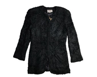 May include: A black fuzzy jacket with a zipper closure and a gold zipper pull.