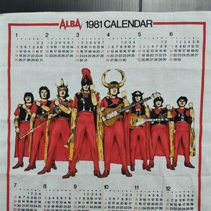 May include: A vintage 1981 calendar featuring a band called ALBA. The band members are dressed in red and black costumes and are holding musical instruments. The calendar is printed on a white background.