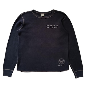 May include: A dark navy blue long-sleeve thermal shirt with a crew neckline. The chest features the white text PROPERTY OF USAAF, and the lower right side displays a circular Army Air Force emblem with wings and a star in white ink.