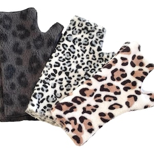 May include: Three pairs of fingerless gloves in different leopard print patterns. One pair is black and gray, one is white and gray, and one is white, brown, and gray.