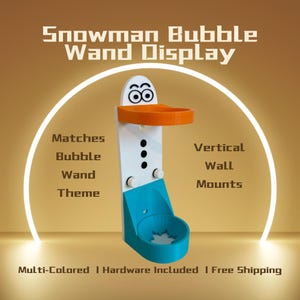 May include: A multi-colored snowman-themed bubble wand display. The display is white, orange, and blue, with the text "Snowman Bubble Wand Display." It features a round orange holder and a blue base with a star-shaped design.