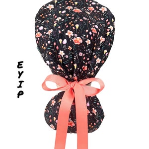 Floral ponytail scrub cap for women by EYIP, mini flowers on black surgical cap, peach ribbon & clear buttons