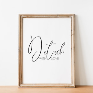 May include: A framed print with the text "Detach with Love" in a cursive font. The frame is a light brown wood.
