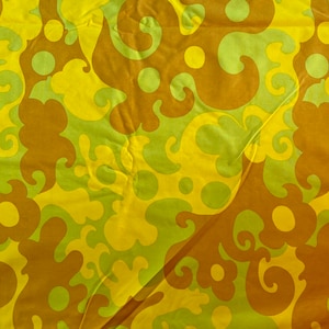 May include: Abstract fabric with a swirling pattern in shades of yellow, brown, and green.