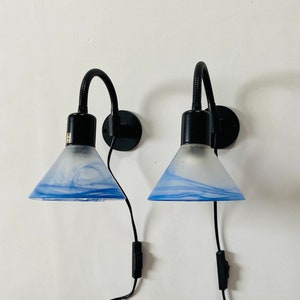 A pair of Danish sconces with white and blue opaque glass shades. Cool 1980s design