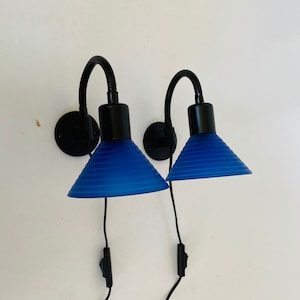 A pair of Danish sconces with white and blue opaque glass shades. Cool 1980s design