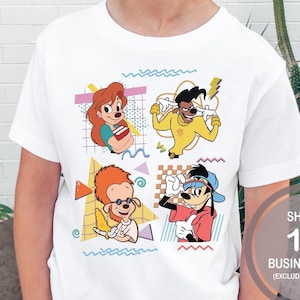May include: White t-shirt with a retro-style graphic featuring characters from the Disney animated series 'A Goofy Movie'. The graphic includes Goofy, Max Goofy, Roxanne, and Pete. The shirt has a crew neck and short sleeves.