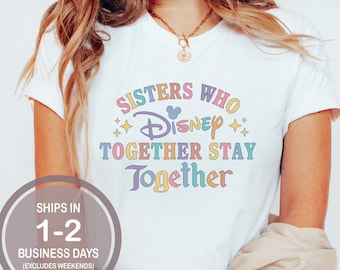 May include: White t-shirt with a rainbow graphic that says "Sisters who Disney together stay together".