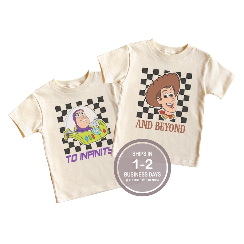 May include: Two cream-colored t-shirts featuring cartoon characters. One shirt has Buzz Lightyear in a spaceship with the text "TO INFINITY". The other shirt has Woody with the text "AND BEYOND". Both shirts have a black and white checkered background.