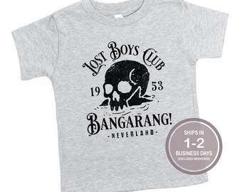 May include: Gray short-sleeved t-shirt with a black skull graphic and the text "Lost Boys Club 19 53 Bangarang! -Neverland- "