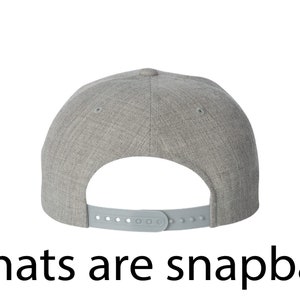 May include: Gray heather snapback hat with a plastic adjustable strap in the back.