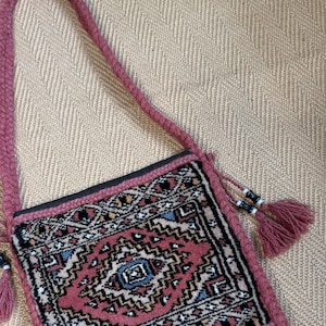 Vintage carpet bag with tassels.