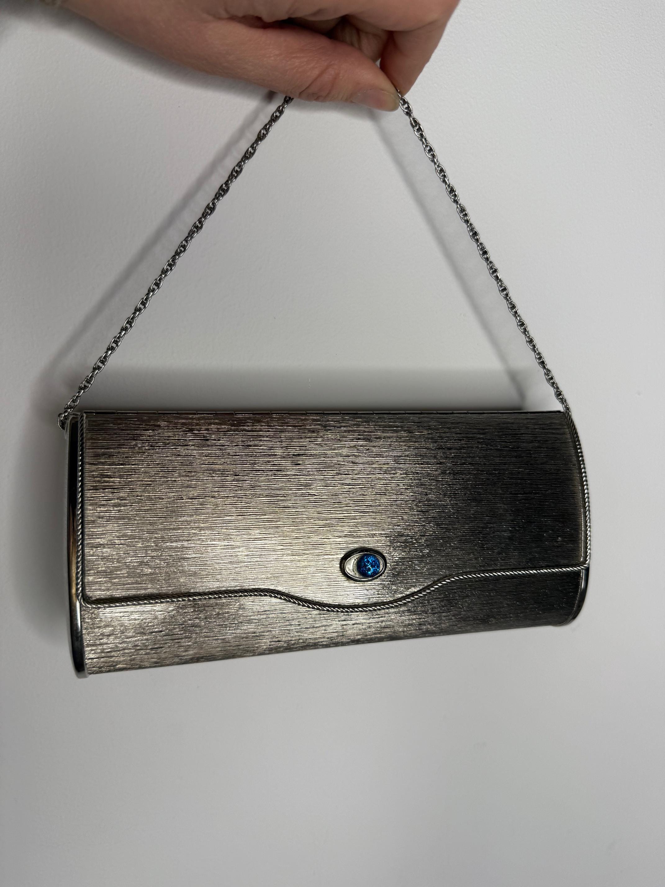 A vintage silver tone metal handbag.