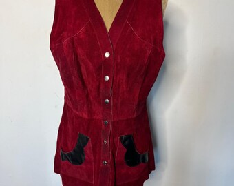 May include: A sleeveless red suede vest with a button-up front and black leather accents on the pockets.