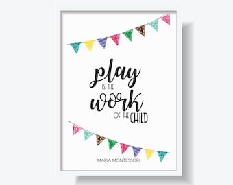May include: White framed print with the quote "play is the work of the child" in black script. Colorful triangle banners are at the top and bottom. The print also includes "Maria Montessori" and the "montessori factory" logo.