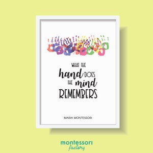 May include: A white framed print with a quote by Maria Montessori: "What the hand does the mind remembers." The quote is surrounded by colourful handprints.