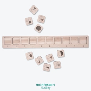 May include: A wooden Montessori fraction circle set with 10 fraction pieces and a wooden tray with 10 slots labeled with fractions from 1/1 to 1/10. The fraction pieces are scattered around the tray.