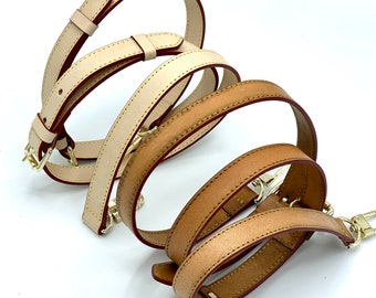May include: Four leather straps in different sizes, two are beige and two are brown. The straps are woven together and have gold hardware.