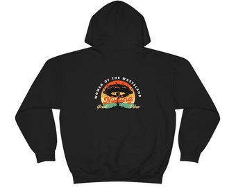 May include: Black hooded sweatshirt with a graphic on the back. The graphic features a stylized mushroom cloud with the words "Nuking" and "Women of the Wasteland, Great Vibes" in a retro color scheme.